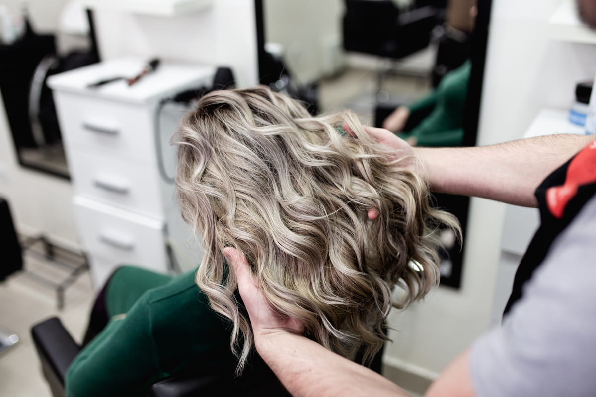 A blonde woman getting a haircut in boston