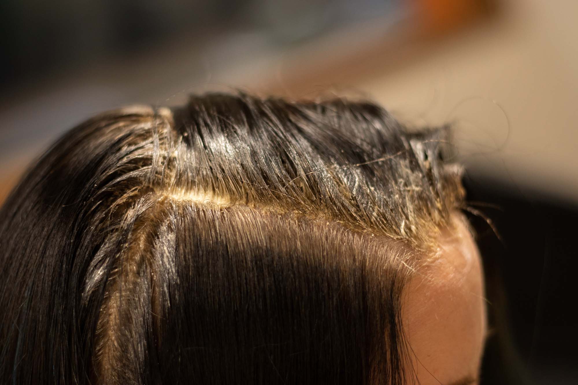 a woman getting a blonde hair treatment in boston