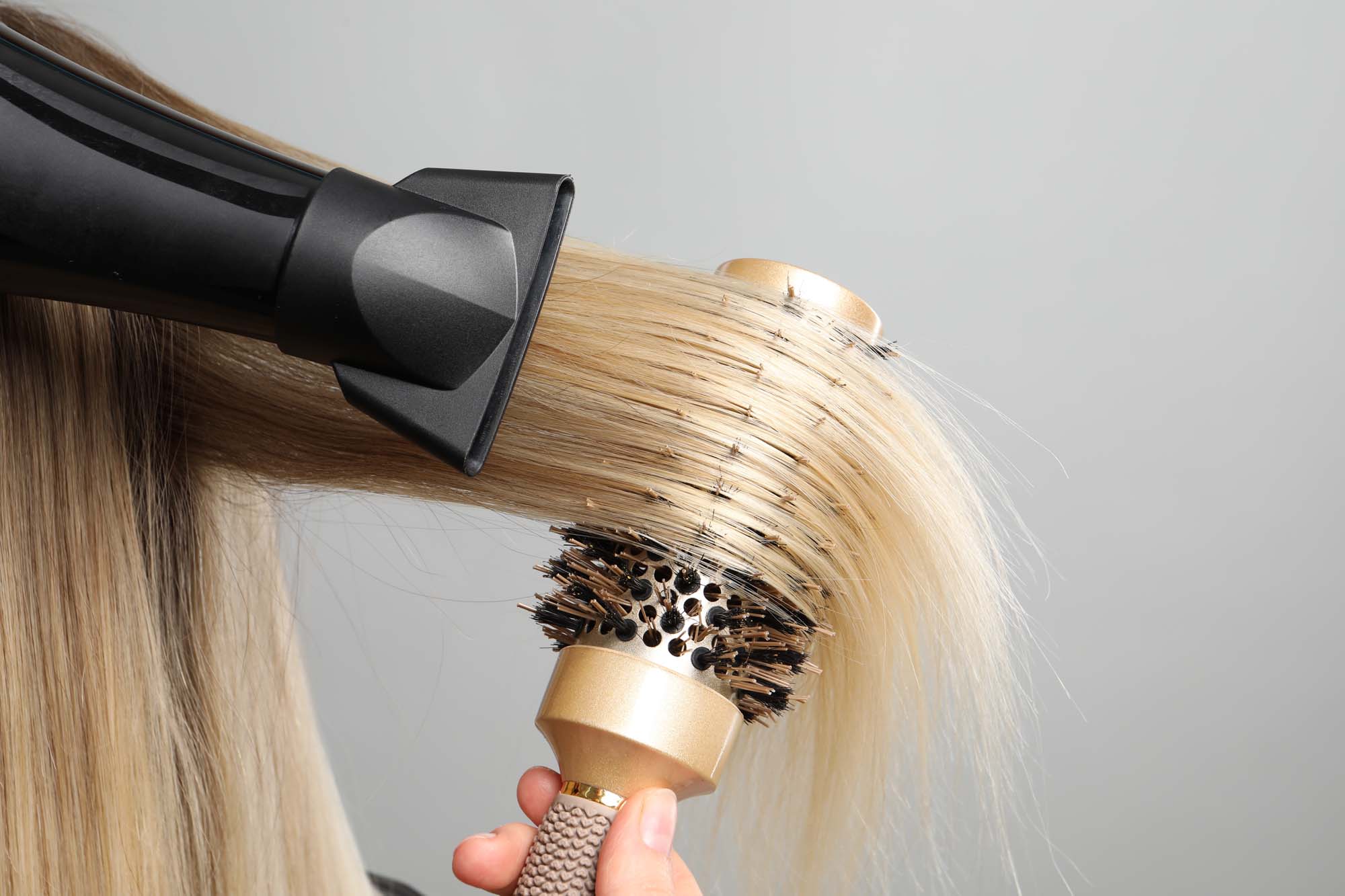 a woman getting a blonde hair treatment in boston