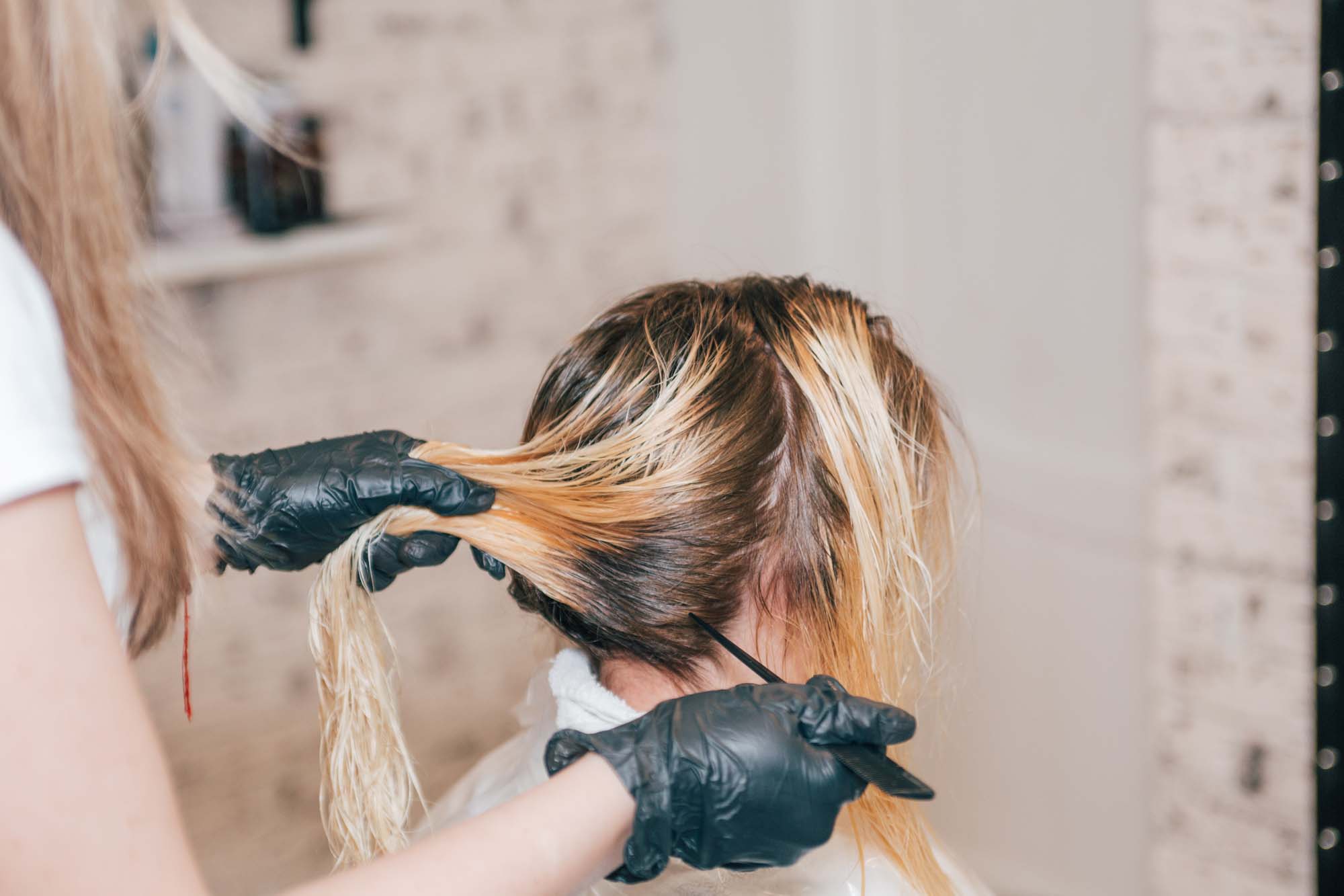 a woman getting a blonde hair treatment in boston